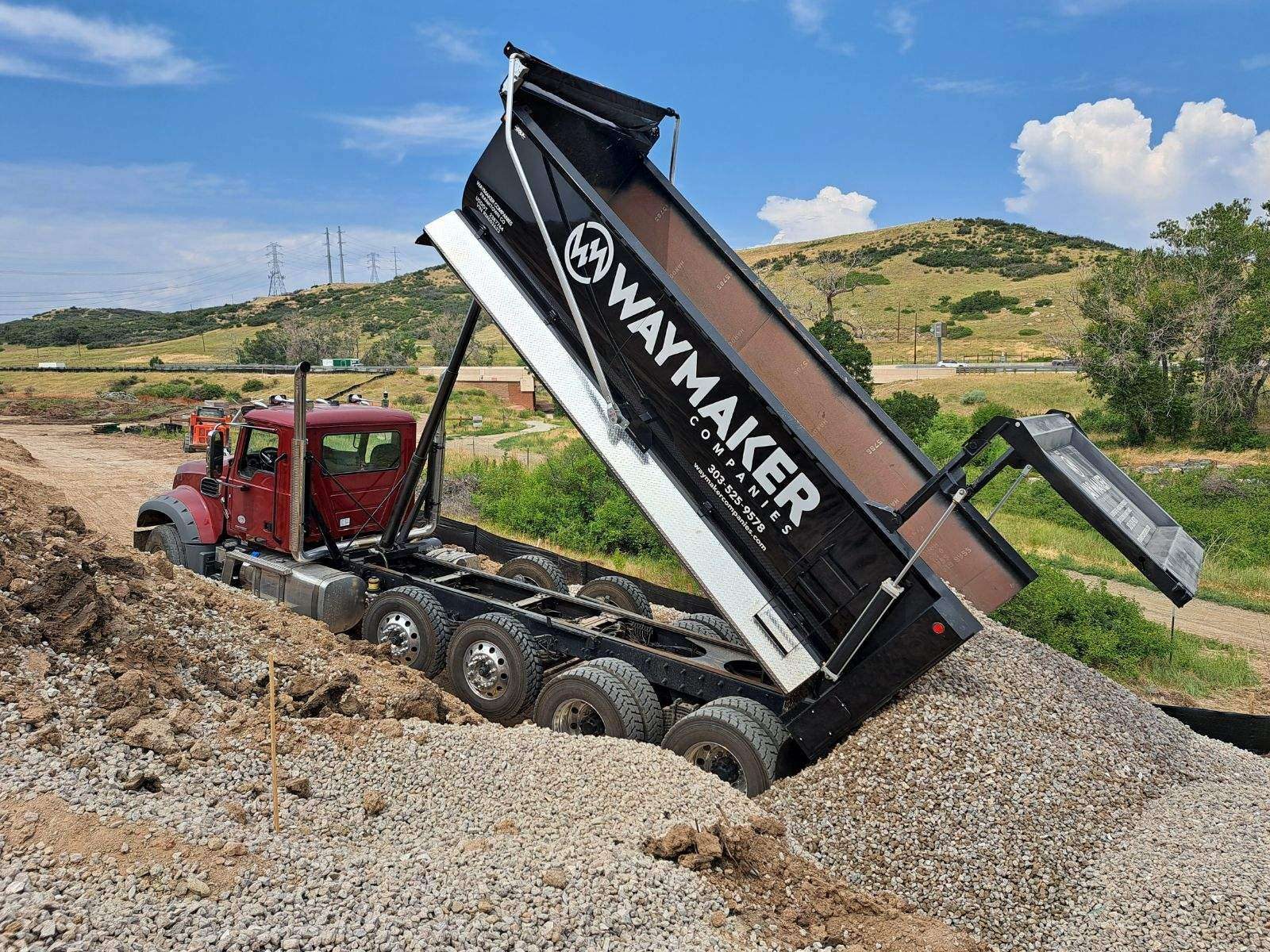 WayMaker dump truck spreading road base in Douglas County