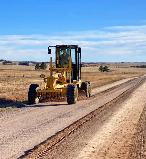 WayMaker crew grading a road in Douglas County